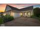 Charming brick home with an attached garage, inviting front porch, and well-manicured landscaping at 1905 Persimmon Grove Dr, Indianapolis, IN 46234