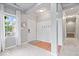 Bright foyer with wood floors, a stylish coat rack, and a staircase leading to the upper level at 1905 Persimmon Grove Dr, Indianapolis, IN 46234