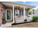 Inviting front porch featuring white columns, potted plants, and a decorative wreath on the green front door at 1905 Persimmon Grove Dr, Indianapolis, IN 46234