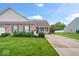 Well-maintained brick home with a green lawn, neat landscaping, and a charming front porch at 1905 Persimmon Grove Dr, Indianapolis, IN 46234