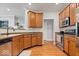 Modern kitchen with stainless steel appliances, wood cabinets, and subway tile backsplash at 1905 Persimmon Grove Dr, Indianapolis, IN 46234