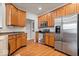 Stylish kitchen featuring stainless steel appliances, wood cabinets and ample counter space at 1905 Persimmon Grove Dr, Indianapolis, IN 46234