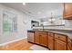 Well-lit kitchen featuring stainless steel appliances and warm wood cabinets at 1905 Persimmon Grove Dr, Indianapolis, IN 46234