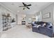 Spacious living room with a fireplace, neutral color palette, and large windows providing ample natural light at 1905 Persimmon Grove Dr, Indianapolis, IN 46234