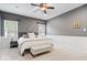 This main bedroom features soft carpet, a ceiling fan, and two large windows at 1905 Persimmon Grove Dr, Indianapolis, IN 46234