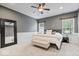 Spacious main bedroom features a ceiling fan, large mirror, and neutral decor at 1905 Persimmon Grove Dr, Indianapolis, IN 46234