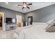 The spacious main bedroom includes a TV, ensuite bathroom, and large mirror at 1905 Persimmon Grove Dr, Indianapolis, IN 46234