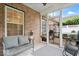 Inviting screened porch features brick walls, comfortable seating, and views of the well-maintained backyard and patio area at 1905 Persimmon Grove Dr, Indianapolis, IN 46234