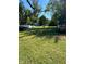 Expansive front yard with lush green grass, mature trees, and ample parking space at 1920 Kildare Ave, Indianapolis, IN 46218