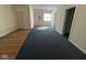 Open-concept living room featuring mixed flooring and multiple doorways for easy access and flow at 1920 Kildare Ave, Indianapolis, IN 46218