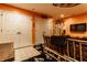 Basement includes a wooden sofa, tile floor, and white closet doors with orange walls, with a TV in the corner at 2017 Rhettsbury St, Carmel, IN 46032