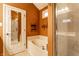 Bathroom featuring a large tub, glass enclosed shower, and tile flooring at 2017 Rhettsbury St, Carmel, IN 46032