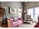 Cozy bedroom with a sitting area, pink couch, and accent chair at 2017 Rhettsbury St, Carmel, IN 46032