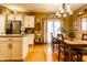 Charming dining room with a rustic table, elegant chandelier, and access to the adjacent kitchen area at 2017 Rhettsbury St, Carmel, IN 46032