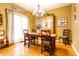 Charming dining area featuring rustic wooden table with bright chandelier and large window with natural light at 2017 Rhettsbury St, Carmel, IN 46032