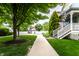 Sidewalk view of homes with well-manicured lawns and trees that shows an appealing community setting at 2017 Rhettsbury St, Carmel, IN 46032