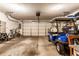 Spacious garage with a golf cart, bike, and overhead storage, offering ample room for vehicles and tools at 2017 Rhettsbury St, Carmel, IN 46032