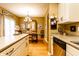 Well-lit kitchen with island featuring stainless dishwasher and sink, flowing into a comfortable dining area at 2017 Rhettsbury St, Carmel, IN 46032