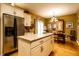 Updated kitchen with stainless appliances, tile countertop island, light cabinetry, and open view to dining area at 2017 Rhettsbury St, Carmel, IN 46032
