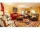 Spacious living room featuring a decorative rug, a ceiling fan, and comfortable seating for relaxing or entertaining at 2017 Rhettsbury St, Carmel, IN 46032