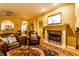 Spacious living room features a cozy fireplace, comfortable leather seating, and a vibrant area rug at 2017 Rhettsbury St, Carmel, IN 46032