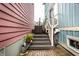 Outdoor deck with stairs featuring a cozy seating area, potted plants, and a metal watering can at 2017 Rhettsbury St, Carmel, IN 46032