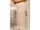 Close up of a new shower with a glass door and white marble-like tile at 2017 Rhettsbury St, Carmel, IN 46032