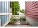 Charming side yard with a pathway leading to a white picket fence and lush landscaping at 2017 Rhettsbury St, Carmel, IN 46032