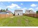 Wide backyard features a wooden deck, a house, lawn, and a fence, offering privacy and outdoor space at 2111 S A St, Elwood, IN 46036