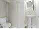 Half bathroom featuring a pedestal sink and toilet, designed for efficient use of space at 2111 S A St, Elwood, IN 46036
