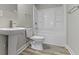 Clean bathroom with modern pedestal sink, toilet, and shower-tub combination, complemented by stylish flooring at 2111 S A St, Elwood, IN 46036