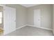 Clean, neutral bedroom with plush carpeting and ample natural light from a window at 2111 S A St, Elwood, IN 46036