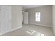 Spacious bedroom with neutral carpet, showcasing a walk-in closet and en-suite bathroom at 2111 S A St, Elwood, IN 46036