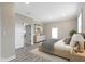 Staged spacious bedroom featuring wood-look flooring, neutral paint, recessed lighting, and a closet with access to other rooms at 2111 S A St, Elwood, IN 46036