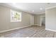 Spacious bedroom featuring wood-look flooring, neutral paint, recessed lighting and a closet with access to additional rooms at 2111 S A St, Elwood, IN 46036
