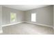 Bright bedroom featuring neutral walls, plush carpeting, and natural light from two windows at 2111 S A St, Elwood, IN 46036