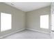 Bright and airy bedroom featuring neutral carpet, multiple windows, and fresh paint at 2111 S A St, Elwood, IN 46036