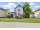 Charming home featuring a white exterior with black trim and a well-manicured lawn at 2111 S A St, Elwood, IN 46036