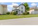 Charming home featuring a white exterior with black trim and a well-manicured lawn at 2111 S A St, Elwood, IN 46036