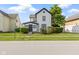Charming home featuring a white exterior with black trim and a well-manicured lawn at 2111 S A St, Elwood, IN 46036