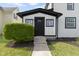 Welcoming entrance with a black front door and manicured landscaping at 2111 S A St, Elwood, IN 46036