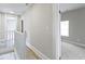 Upstairs hallway with white wood railing leading to bedrooms with new neutral carpeting at 2111 S A St, Elwood, IN 46036