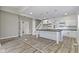 Bright, open-concept kitchen features a large island, white cabinetry, stainless steel appliances, and stylish pendant lighting at 2111 S A St, Elwood, IN 46036
