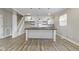 Bright, open-concept kitchen features a large island, white cabinetry, stainless steel appliances, and stylish pendant lighting at 2111 S A St, Elwood, IN 46036