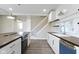 Bright kitchen features a large island with stove, white cabinetry, stainless steel appliances, and stylish pendant lighting at 2111 S A St, Elwood, IN 46036