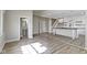 Open-concept living space with wood-look floors, open stairway, and modern kitchen view at 2111 S A St, Elwood, IN 46036