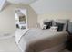 Comfortable bedroom featuring a large bed, soft lighting, and calming neutral tones at 2223 Shaftesbury Rd, Carmel, IN 46032