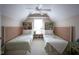 Bright bedroom features two twin beds, built-in shelves, and a ceiling fan at 2223 Shaftesbury Rd, Carmel, IN 46032