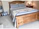 Comfortable bedroom with a wooden bed frame, soft bedding, and a nightstand with a lamp at 2223 Shaftesbury Rd, Carmel, IN 46032