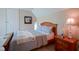 Comfortable bedroom with a wooden bed frame, soft linens, and a bedside table at 2223 Shaftesbury Rd, Carmel, IN 46032